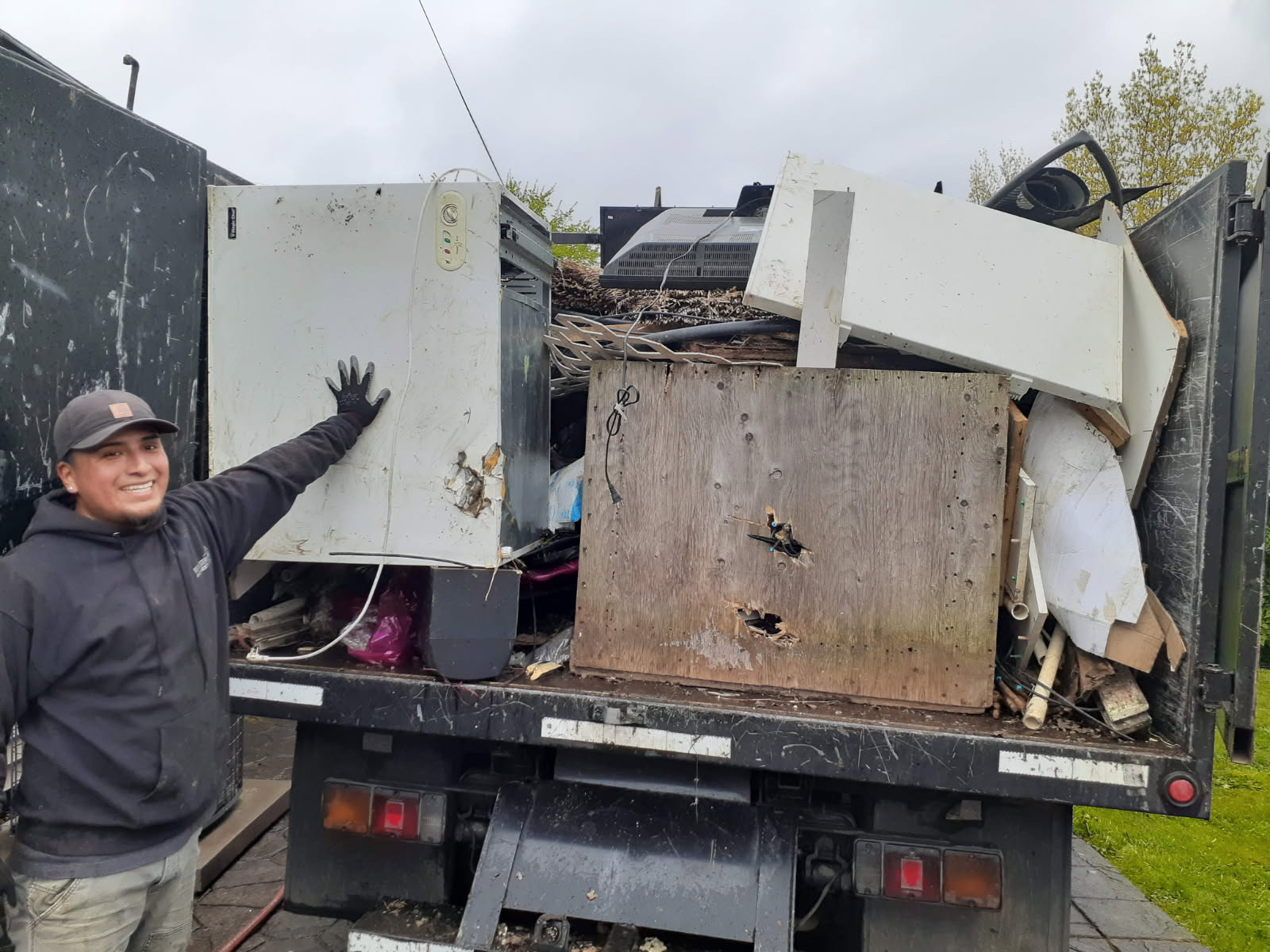 Dump It Express crew member working a loaded truck job
